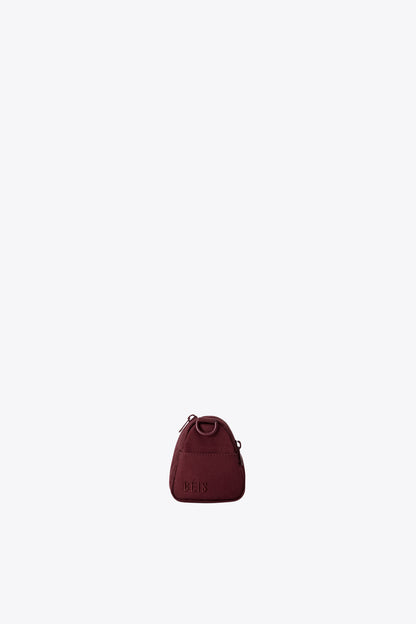 The Expandable Crossbody Charm in Burgundy